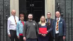 Relatives of victims of the NHS infected blood scandal hand in a letter to 10 Downing Street News Clip
