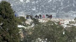 CLEAN : Athens residents enjoy snowy day on the foothills of the Acropolis News Clip