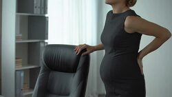 Pregnant business lady reading report in office, feeling back pain, muscle spasm Stock Footage
