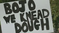 Hospitality workers with banner BOJO WE KNEAD DOUGH protesting in Parliament Square News Clip