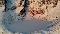 Aerial view of lake in snowy valley Stock Footage