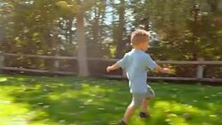 Little Boy Playing in a Park Stock Footage