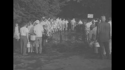 People wait in line for water in flood-affected area News Clip