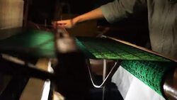 Craftsman working on huge old wooden brocade weaving looms Stock Footage