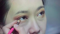 Professional make-up artist making up her model face Stock Footage