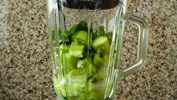 Preparation of cocktail from cucumbers, mentha and a lime. Slow motion.	Shooting in kitchen. Stock Footage