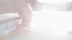 Geothermal spa. Man relaxing in hot spring pool in Iceland. Male enjoying bathing in a blue water lagoon Icelandic tourist attraction Stock Footage
