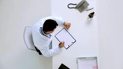 doctor with cardiogram on clipboard at clinic Stock Footage