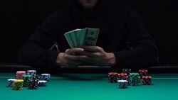 Confident man showing bunch of dollars he won playing in casino, fortune slow-mo Stock Footage