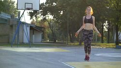 Fitness female doing skipping workout outdoors on a sunny day Stock Footage