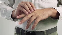 Close up of a man tries to ease the soreness in his hand Stock Footage