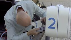 Man plugging cable charger of electric car Stock Footage