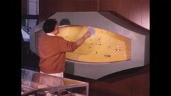 1970s: Woman cleans glass covering museum display on wall Stock Footage