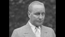 Standing outdoors, US Treasury official Ogden L. Mills reads a statement News Clip