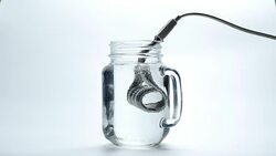 Boiling water with immersion heater Stock Footage