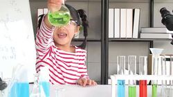 Education Topics:Funny little girl doing experiments in the laboratory.Science and education. Stock Footage