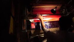 Craftsman working on huge old wooden brocade weaving looms Stock Footage