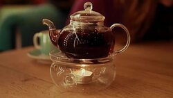 Tea time. Teapot with tea at table Stock Footage