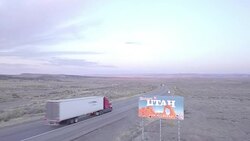 Aerial Drone Footage of Semi-Trucks Passing Utah State Line Stock Footage
