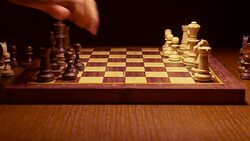 chess player making a move in the game on wooden table Stock Footage