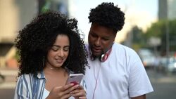 Young Couple Using Mobile Outdoors - Portrait Stock Footage