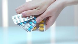Female hand holding tablet blister. Medical capsule pack. Vitamin pill packaging Stock Footage