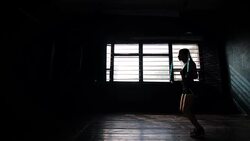 silhouette panning young purposeful female boxer in wrapped bandage hands jumping on skipping rope Stock Footage