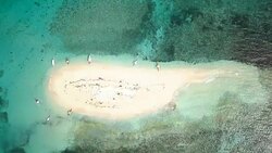 Drone shot aerial view of tropical Island and boat in turquoise pristine water. Directly above view, shot in the Islands of Philippines, Asia. Stock Footage