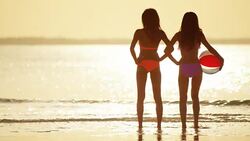 Carefree African American Asian Chinese girls on beach Stock Footage