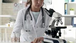 Woman Taking Notes while Studying Samples Stock Footage