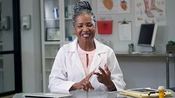 Senior female doctor uses technology to communicate with patient Stock Footage