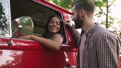 Happy young cheerful mixed race couple having some fun in retro hippie minibus in forest Stock Footage