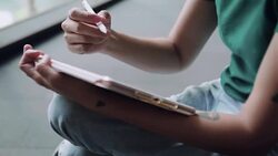 Designer drawing a sketch on tablet using stylus at city Stock Footage