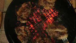 Tasty juicy meat is fried on a grill on a barbecue. Stock Footage