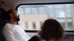 Portrait of A pensive man on the train, looking outside of the window, sleeping Stock Footage