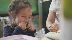 Happy Asian baby girl eating food at home. feed by her mom. Concept : Food,Family,life. Stock Footage