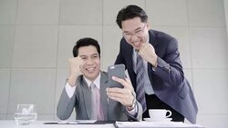 Slow motion - Businessman using smartphone to check stock market data. Male checking stock charts and feeling happy when it uptrend. Stock Footage