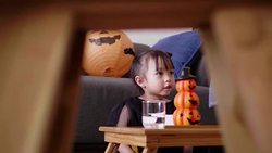 Asian baby girl with pumpkin toy while eating and singing song with mother at home Stock Footage