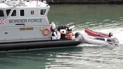 Migrants on board coastguard boat pulling into Dover News Clip