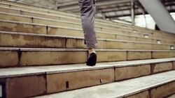 Closed up business woman legs in high-heeled shoes walking up on stairway Stock Footage