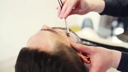 man and barber with straight razor shaving beard Stock Footage