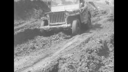 During Korean War, US tanks, trucks, and jeeps moving along muddy roads somewhere in South Korea News Clip