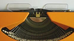 High and side angle footage of a person writing ISLAMOPHOBIA on a typewriter, with sound Stock Footage