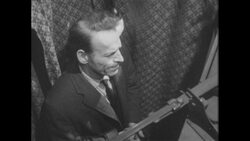 1960s: Man struggles to make a decision inside a voting booth Stock Footage