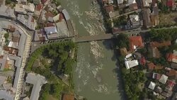 Bird eye view of Kutaisi city on banks of rapid Rioni river, travel to Georgia Stock Footage