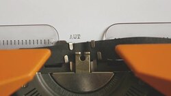 Close up footage of a person writing AUTISMUS on an old typewriter, with sound Stock Footage