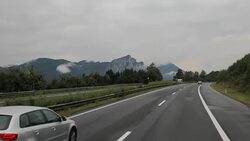 Driving on the highway by the mountain range Stock Footage