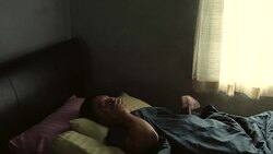 He wakes up in the morning, dark room silhouette light of the window. Stock Footage