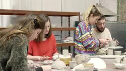Teacher assisting man in pottery studio Stock Footage