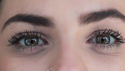 Macro of green eyes opening. Pretty eyes looking to camera smiling Stock Footage